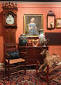 Vignette of antiques, paintings, furniture, clock and toy rocking horse