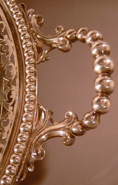 Detail of a handle of a Sheffield silver plated tray retailed by Tiffany and Company