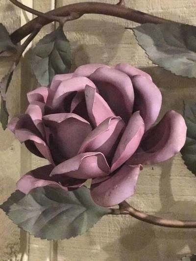 Purple rose detail from polychrome metal wall sculpture